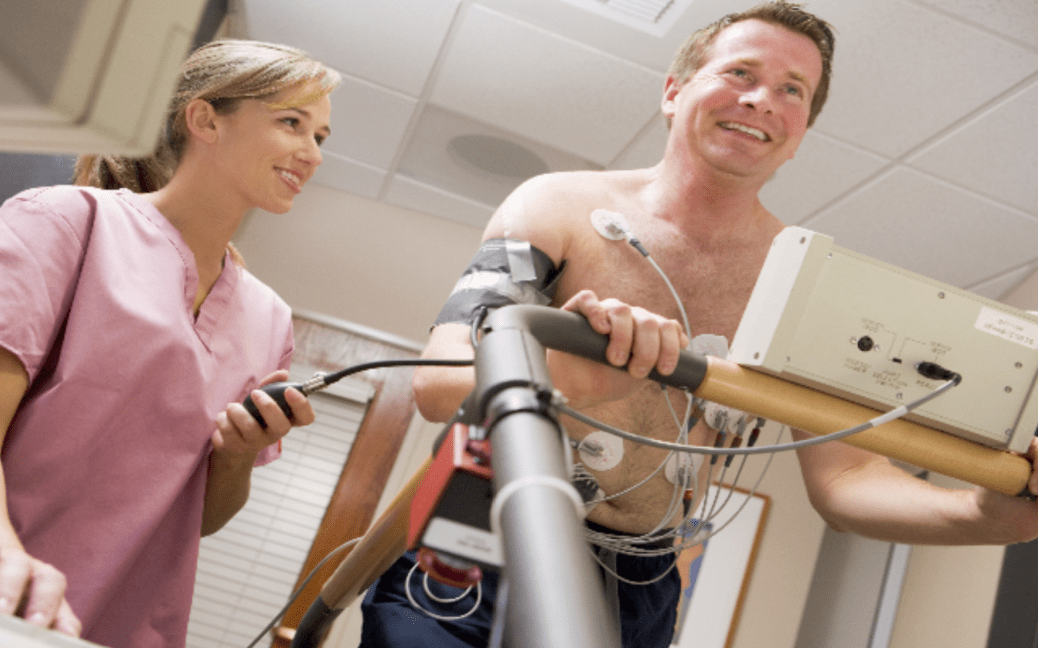 man on treadmill getting tested by doctor